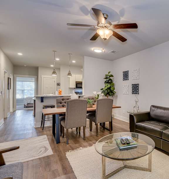 an open kitchen and dining area with a marble counter top