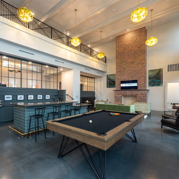 a large room with a pool table and a bar at Livingston Flats Apartments, Chesterfield, VA, 23832