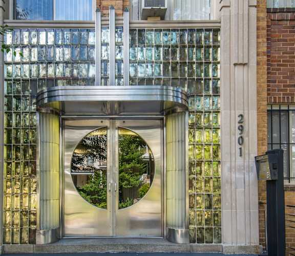 A modern gate entrance to a building with a glass window.