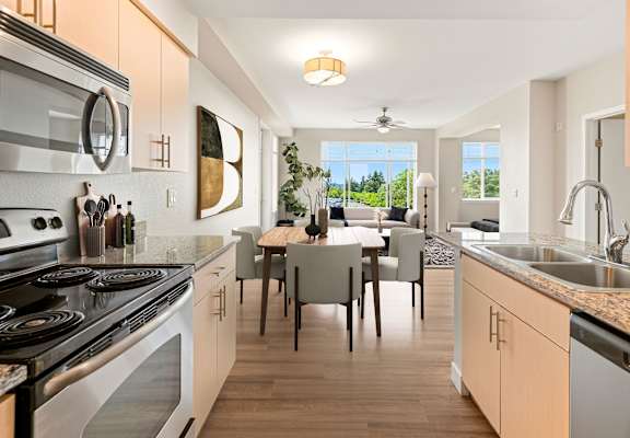 A modern kitchen with a dining table and chairs.