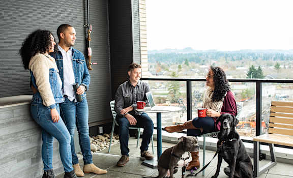 Group of Friends Hanging Out on Patio with Dogs