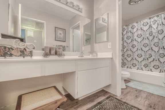 a bathroom with a large mirror and a bathtub at Canyon Club Apartments ,Upland, California, CA