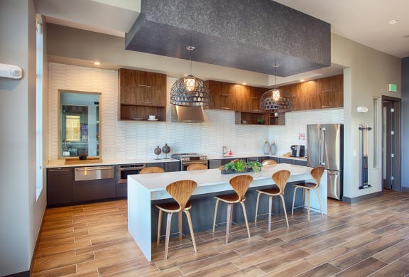 a kitchen with a large island with a breakfast bar