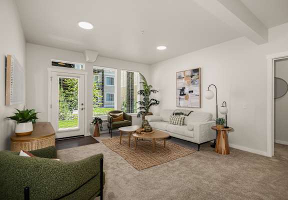 A living room with a white couch and a rug.