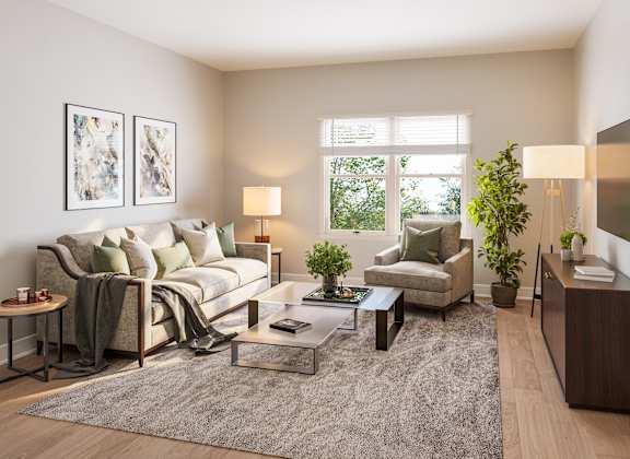 A well-lit living room with a couch, armchair, and coffee table. at Heritage Landing Apartments, Terre Haute, 47803