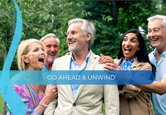 a group of people laughing and embracing each other
