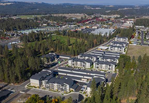 A large building complex surrounded by trees.