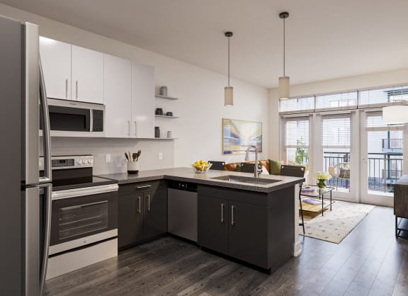 a kitchen with a large island and stainless steel appliances