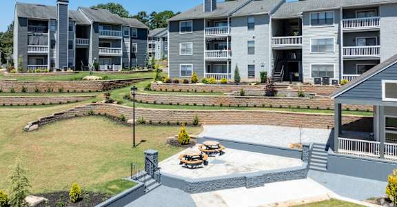 A large apartment complex with a courtyard and picnic tables.