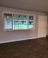 an empty living room with a staircase and a large window