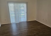 Thumbnail 5 of 7 - A window with blinds is on the wall.