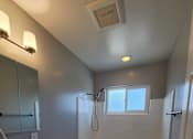 Thumbnail 15 of 17 - a bathroom with a toilet and a sink and a window