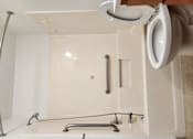 Thumbnail 14 of 15 - a white bathroom with a urinal and a sink and a mirror