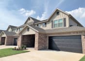 Thumbnail 1 of 60 - Brick Building Exterior with garage