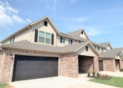 Thumbnail 2 of 60 - Brick Building Exterior with garage