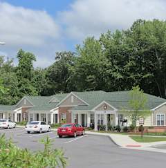 a row of houses with cars parked in a parking lot
