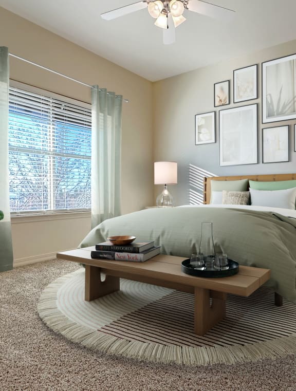 Liberty Bend Apartments, Sandy, Utah, Bedroom with bed, table and artwork on walls.