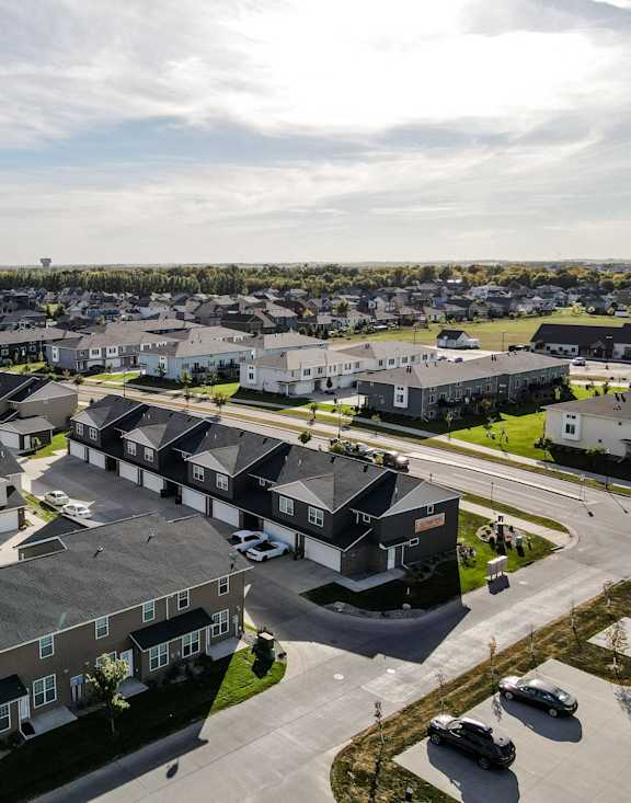 A bird's eye view of a residential area with houses and cars.