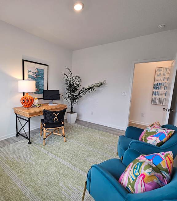A living room with a blue couch and a wooden table.