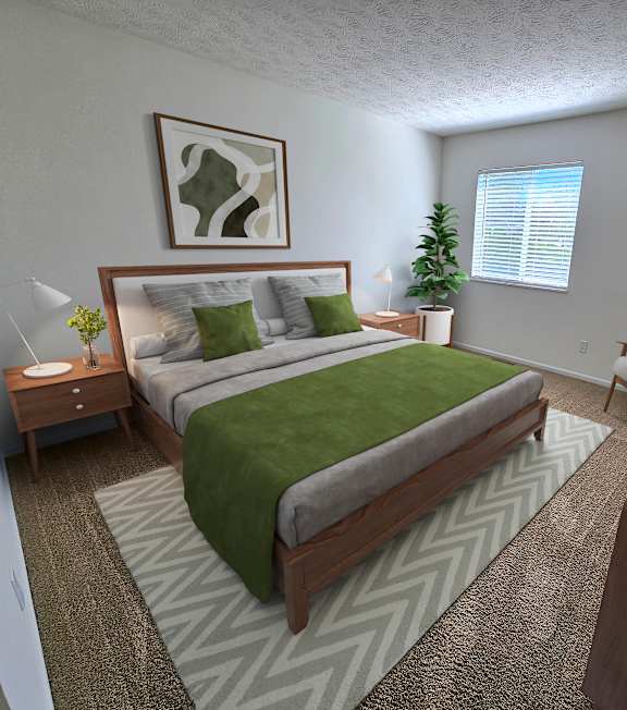A bedroom with a large bed and a green blanket.