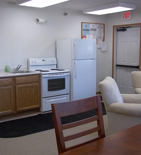 a living room and kitchen with a couch and a table