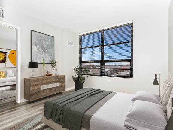 a bedroom with a bed and a large window