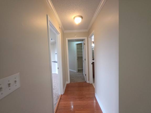 A long hallway with a door at the end.