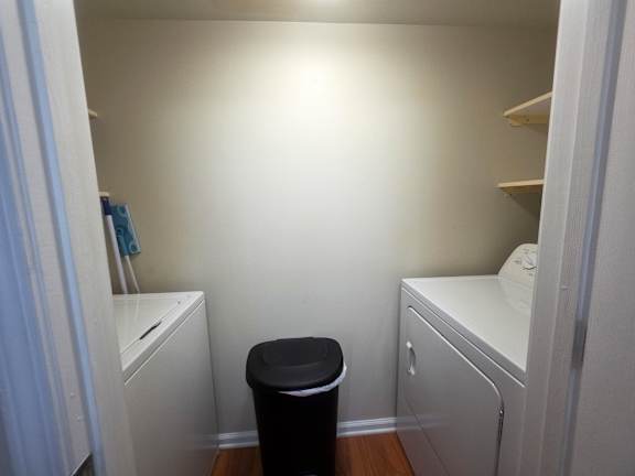 A small bathroom with a toilet, sink, and cabinet.