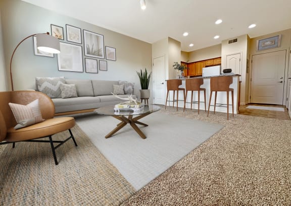 Liberty Bend Apartments, Sandy, Utah, living room with a couch and a table in front of a kitchen