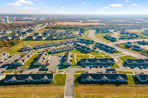 A residential area with houses and cars.