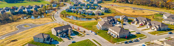 A suburban neighborhood with houses and a road.