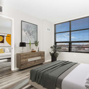 a bedroom with a bed and a large window