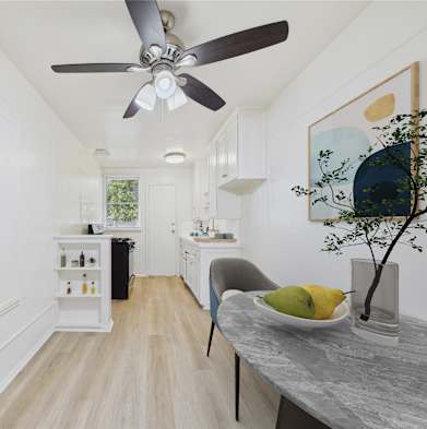 A modern kitchen with a dining table and chairs.