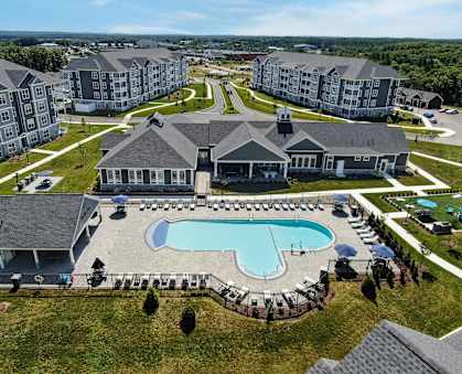an aerial view of an apartment complex with a swimming pool
