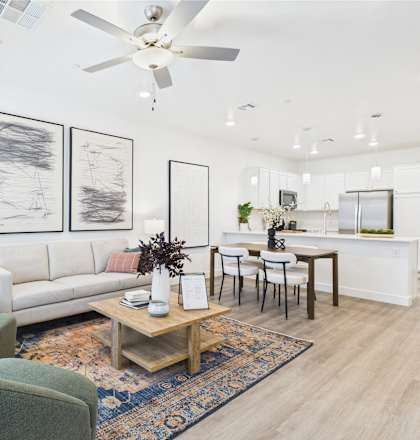 A living room with a sofa, chairs, and a coffee table.