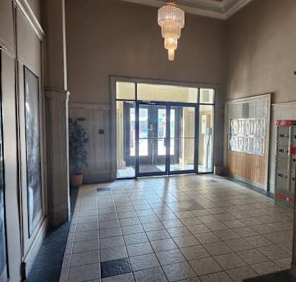A hallway with a chandelier hanging from the ceiling.