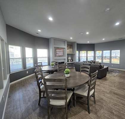 a dining room with a table and chairs and a living room with couches
