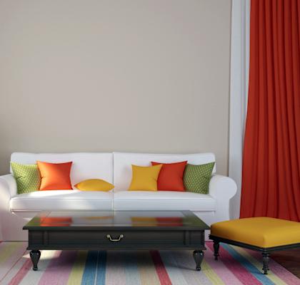 a living room with a white couch and colorful pillows at Overland Gardens, Landover