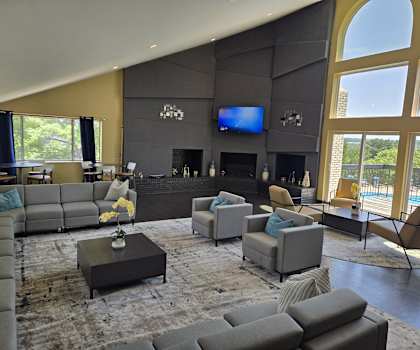 a large living room with couches and chairs and a television