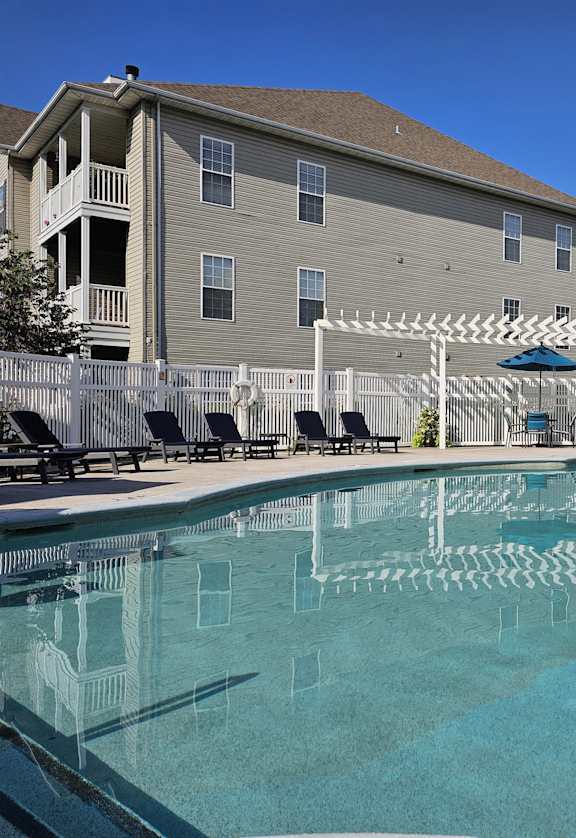a resort style pool with a building in the background