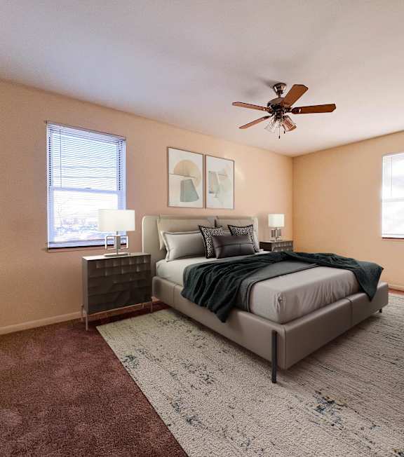 a bedroom with a bed and a ceiling fan at Huntington Green Apartments, University Heights, OH