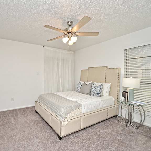a bedroom with a bed and a ceiling fan at Peaks at Northwest Hills Apartments, Austin