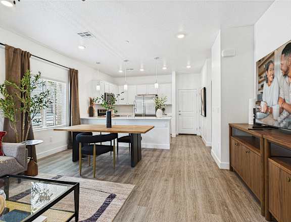 A modern kitchen with a dining table and chairs.