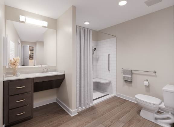 A bathroom with a white toilet and a walk-in shower. at Evergreen Heights Apartments, Toledo, 43614