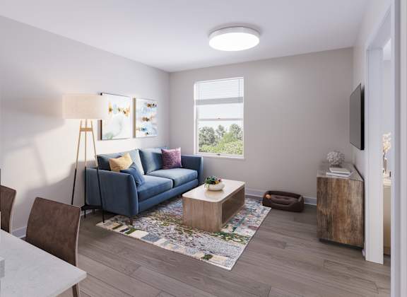 A living room with a blue couch, a wooden coffee table, and a television. at Evergreen Heights Apartments, Ohio, 43614