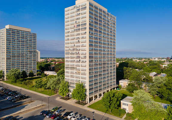 an aerial view of two towers and a parking lot