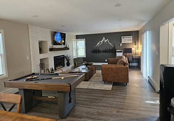 Clubhouse with a pool table and a fireplace.