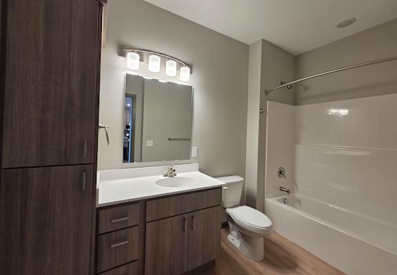 A modern bathroom with a vanity and a mirror.