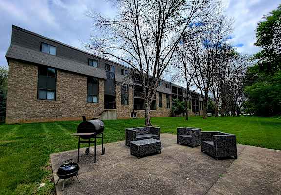 our apartments have a patio with seating and a grill