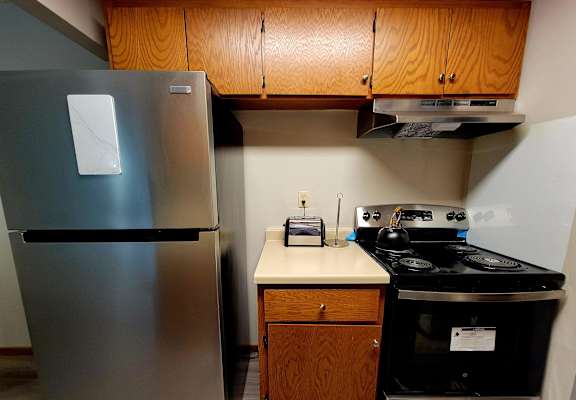 a kitchen with a stove and a refrigerator